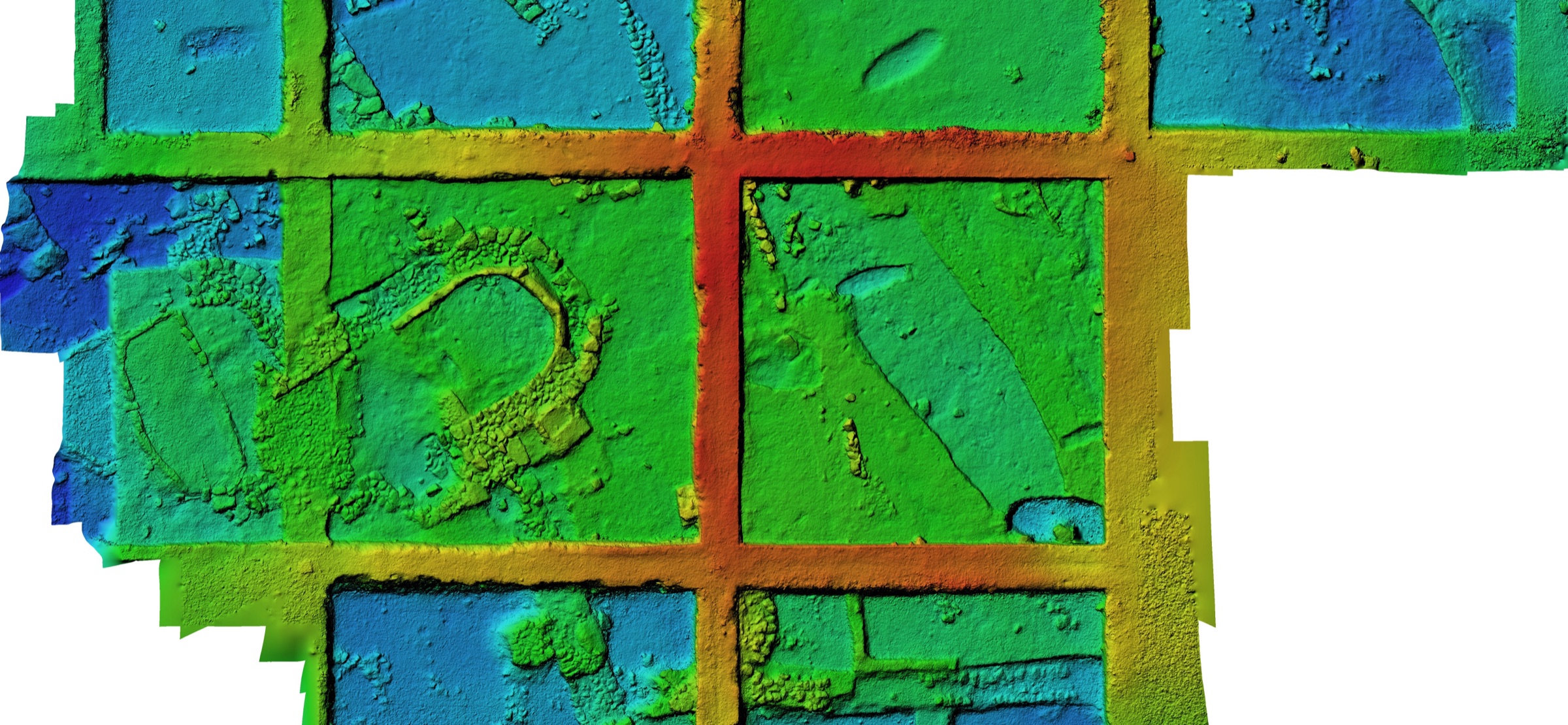 Colour digital elevation model of the Ekşi Höyük trenches: baulks as a red grid, the hollow of the apsidal building and floors in blue-green tones.