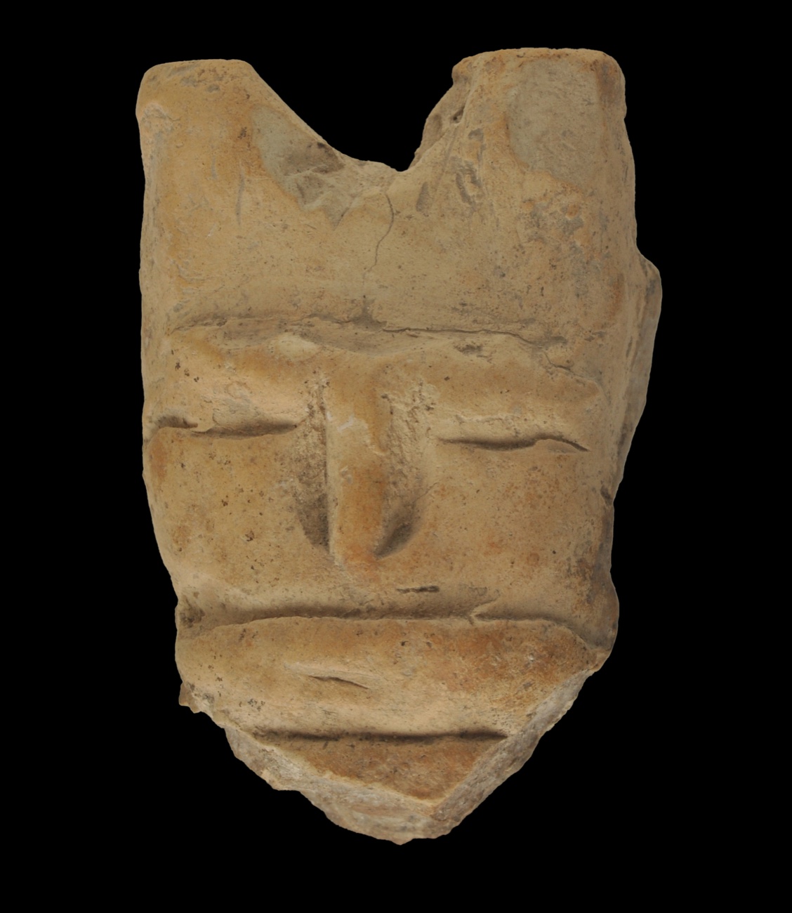 A clay figurine face against a dark background: a modelled nose and eyes marked with incised lines.